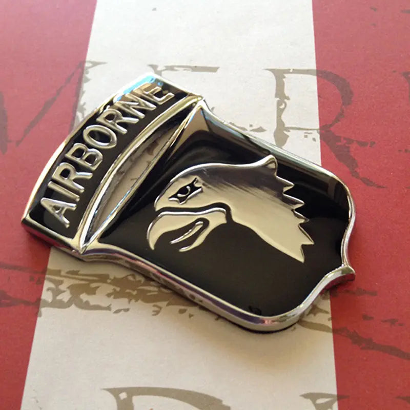 Metallic airborne badge on a red and white background