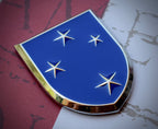 The Americal Division Metal Auto Decal on a red and grey bakground