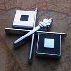 Silver and black Signal Corps Insignia Metal Auto Emblem on a Map