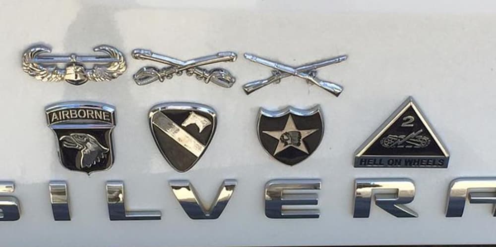 Collection of military emblems on a vehicle's badge