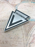 Recondo Badge Car Emblem facing left on a map background