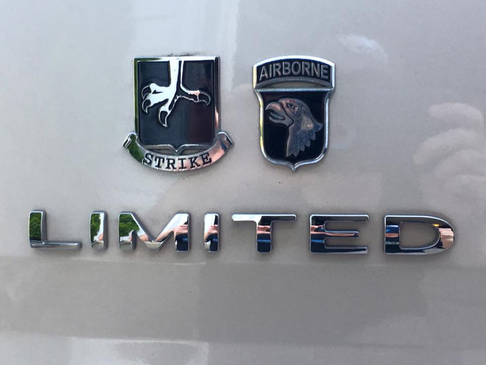 502nd Infantry Regiment Strike Metal Auto Emblem above a limietd decal on a white surface
