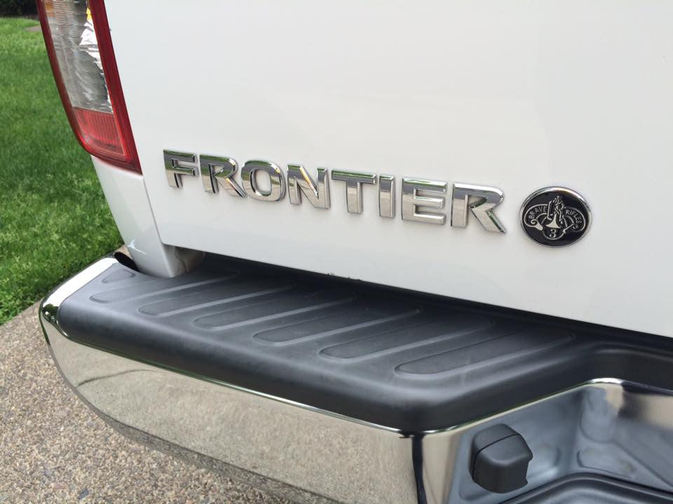 3rd Cavalry Regiment Brave Rifles Metal Car Emblem Next To Frontier Chrome Emblem on a white Tailgate