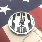 89th Military Police Brigade Emblem with a black and white design on a textured surface with an American flag pattern.