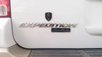 8th Infantry Division Metal Auto Emblem Above Expedition Eddie Bauer Decal on a  rear hatch door