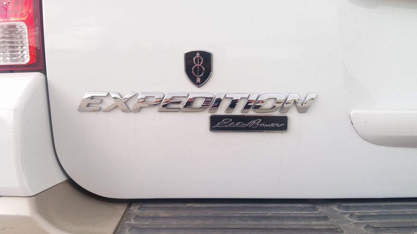 8th Infantry Division Metal Auto Emblem Above Expedition Eddie Bauer Decal on a  rear hatch door