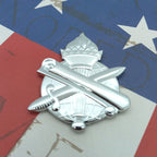 A silver metal Civil Affairs Branch Insignia badge, placed on a red, white, and blue background with distressed star and stripe patterns.