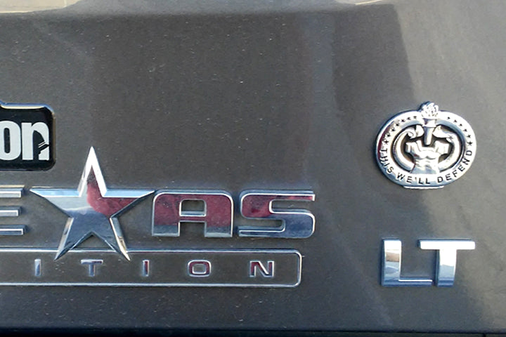 Army Drill Sergeant Badge This We'll Defend Metal Decal on the side of a silver truck