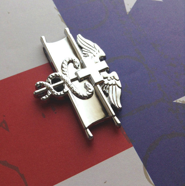 EFMB Metal Car Emblem on a Red White and Blue Background