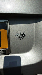 Signal Corps Insignia Metal Auto Emblem on the fender of a silver car